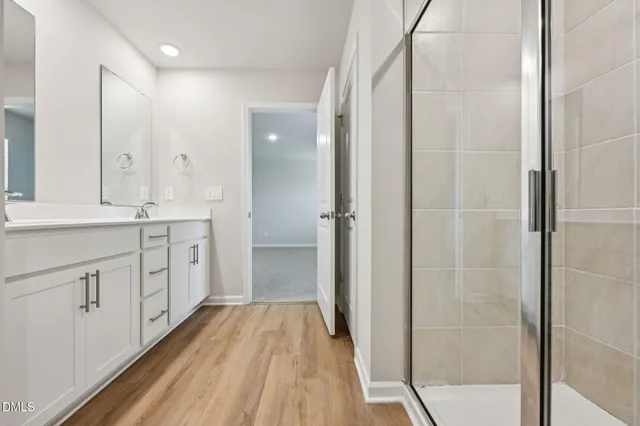a spacious bathroom with a shower and a sink