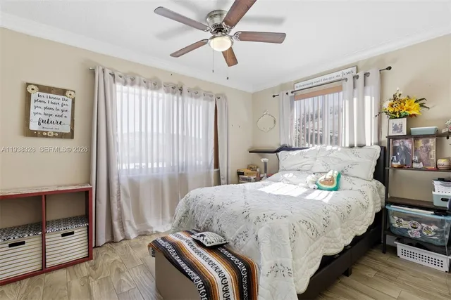 a bedroom with a bed table and window