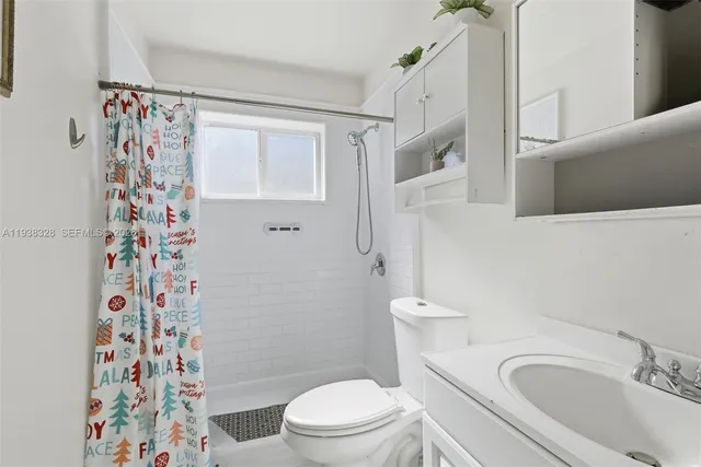 a white toilet sitting next to a bathroom sink