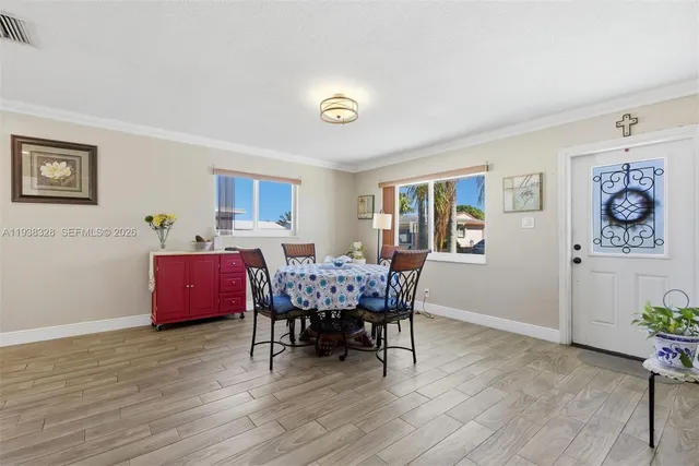 a view of a dining room with furniture and wooden floor