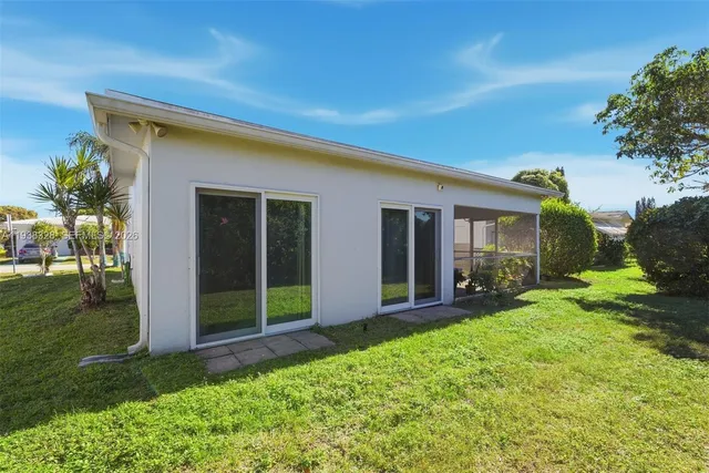 a view of an house with backyard space and garden