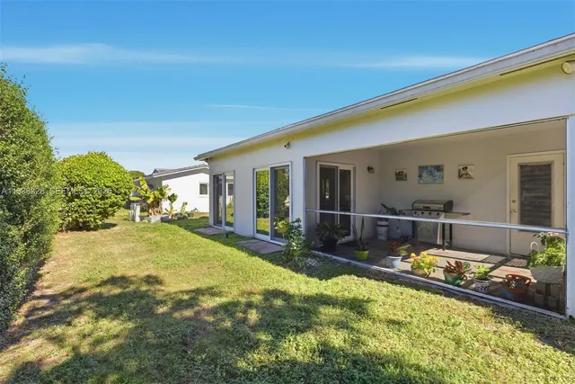 a swimming pool with outdoor seating and yard