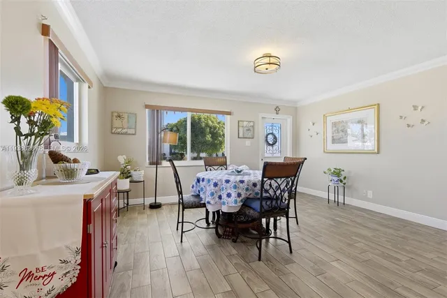a dining room with furniture and wooden floor