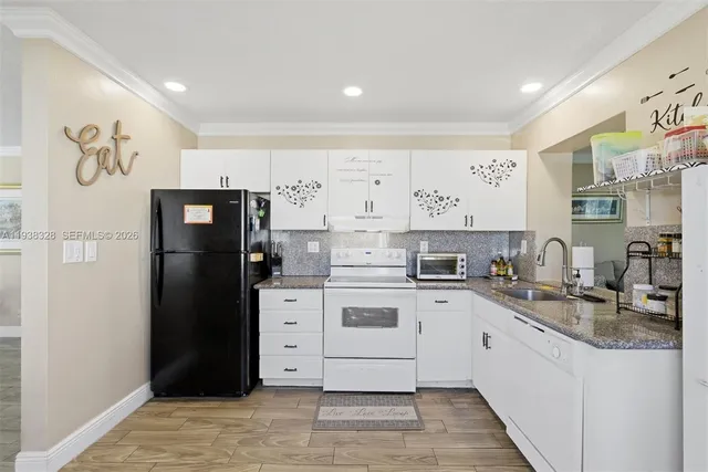 a kitchen with a refrigerator and a sink