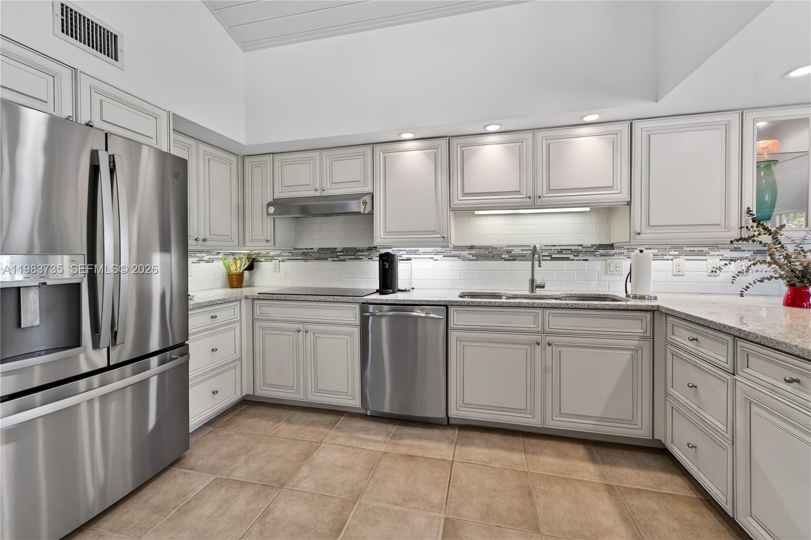 851 Saturn Street, Unit D Jupiter, FL 33477 - Photo 11 of 60 a kitchen with granite countertop cabinets stainless steel appliances and a sink