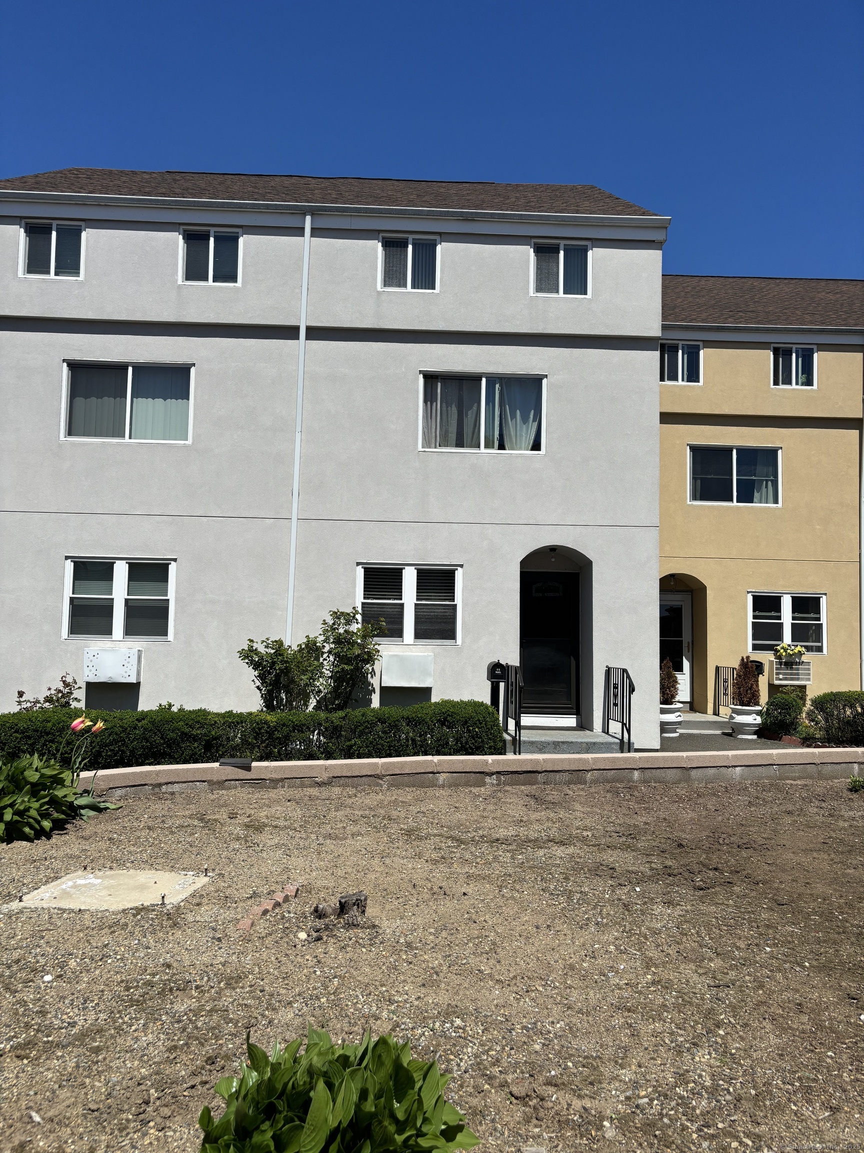 60 Gilmore Street, Unit 21 Bridgeport, CT 06608 - Photo 1 of 13 a front view of a building with garden