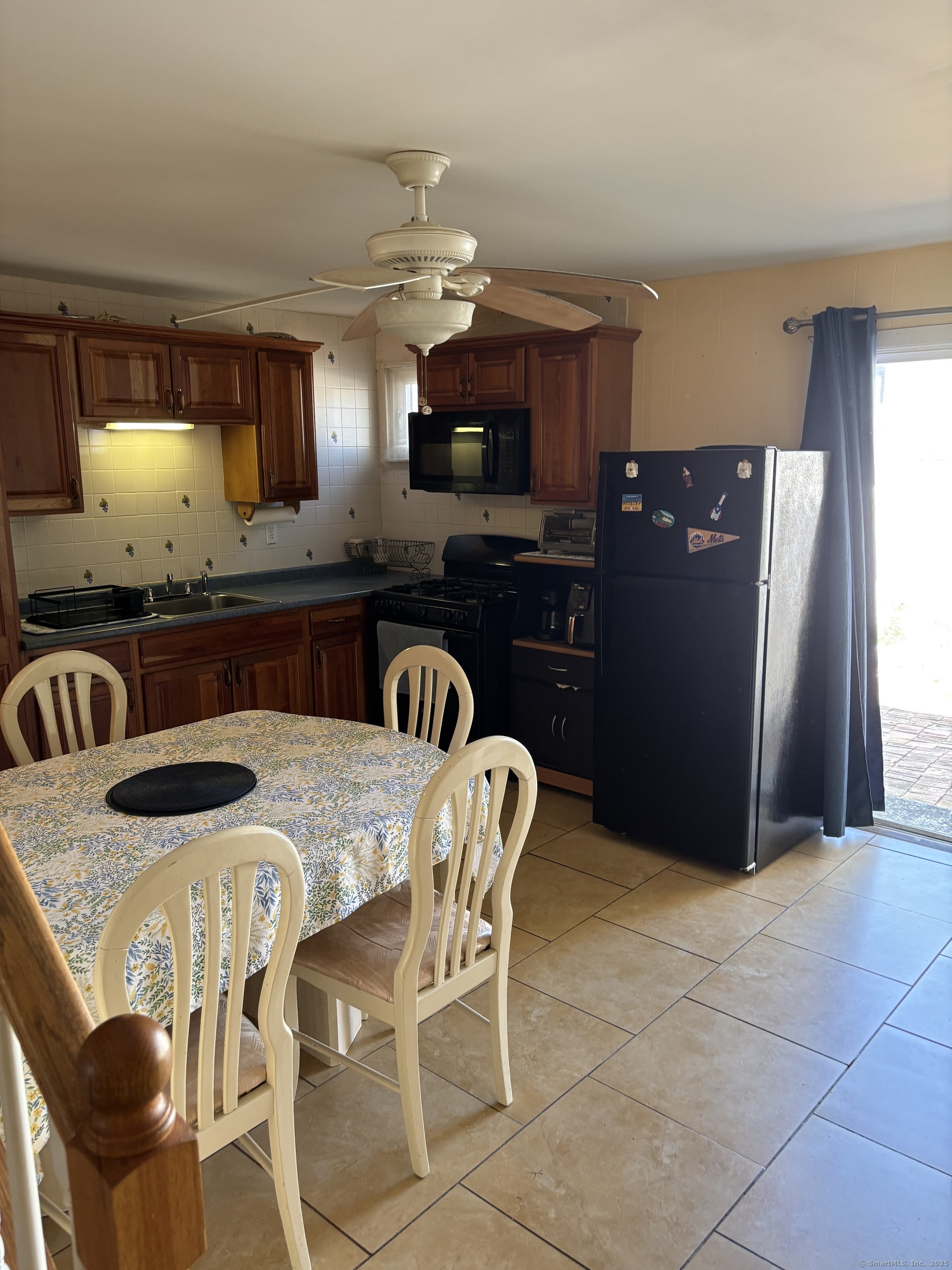 60 Gilmore Street, Unit 21 Bridgeport, CT 06608 - Photo 4 of 13 a kitchen with stainless steel appliances granite countertop a sink a stove a refrigerator a dining table and chairs