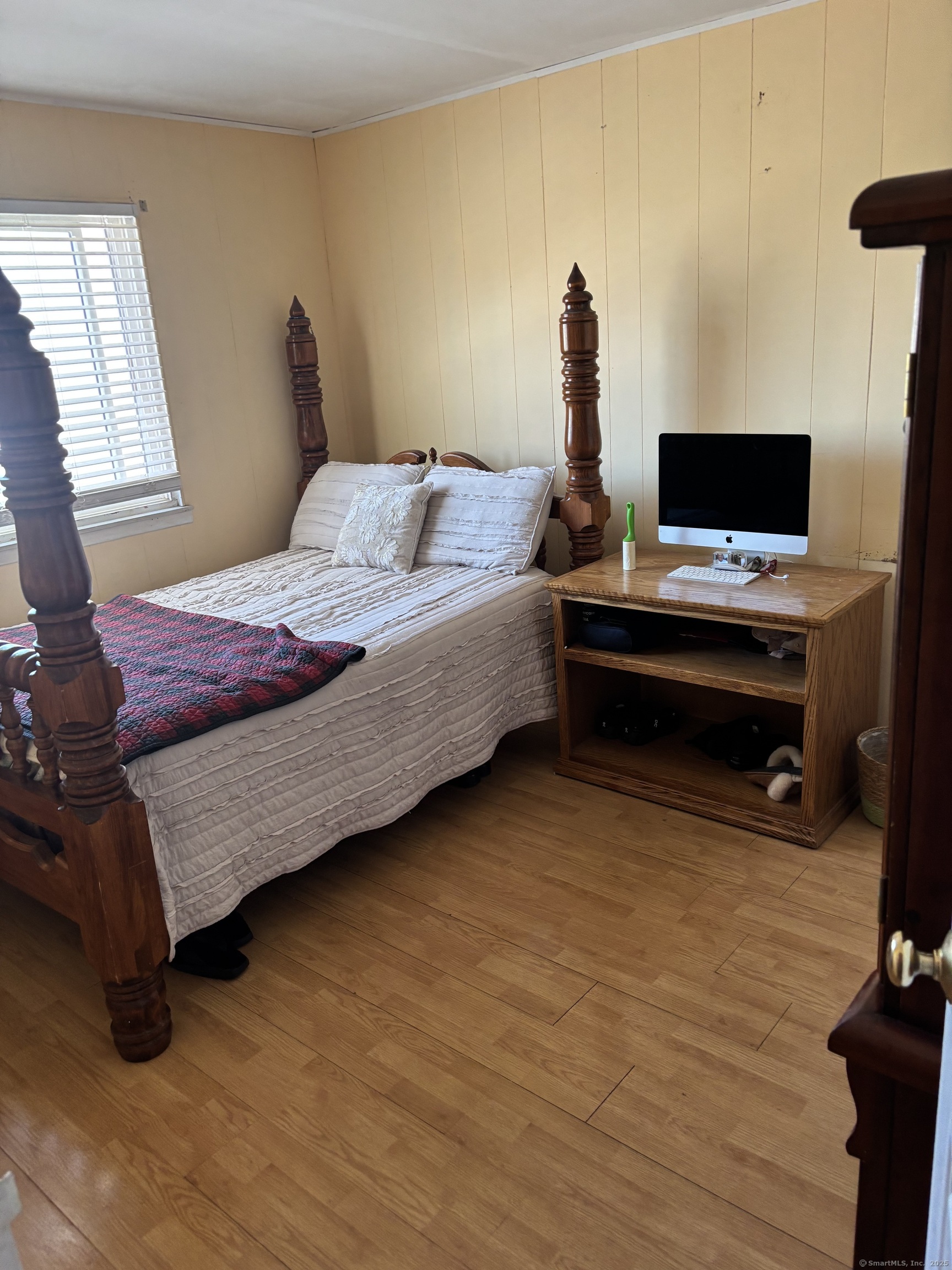 60 Gilmore Street, Unit 21 Bridgeport, CT 06608 - Photo 6 of 13 a bedroom with a bed and a flat tv screen on dresser