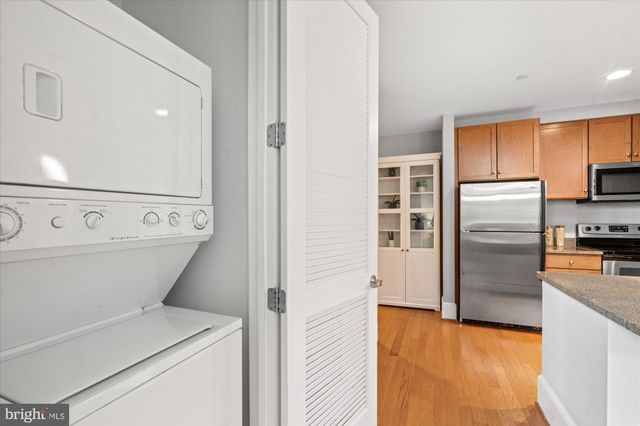 a view of washer and dryer with kitchen in the background