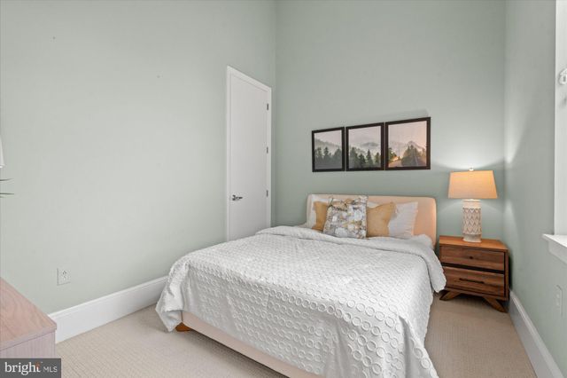 a bedroom with a bed and wall painting