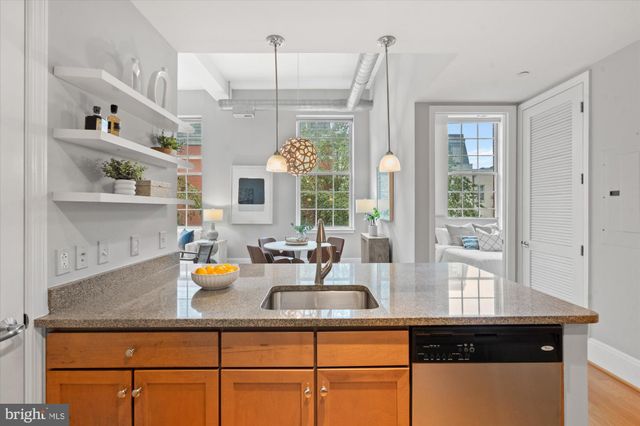 a kitchen with a sink a counter space and cabinets