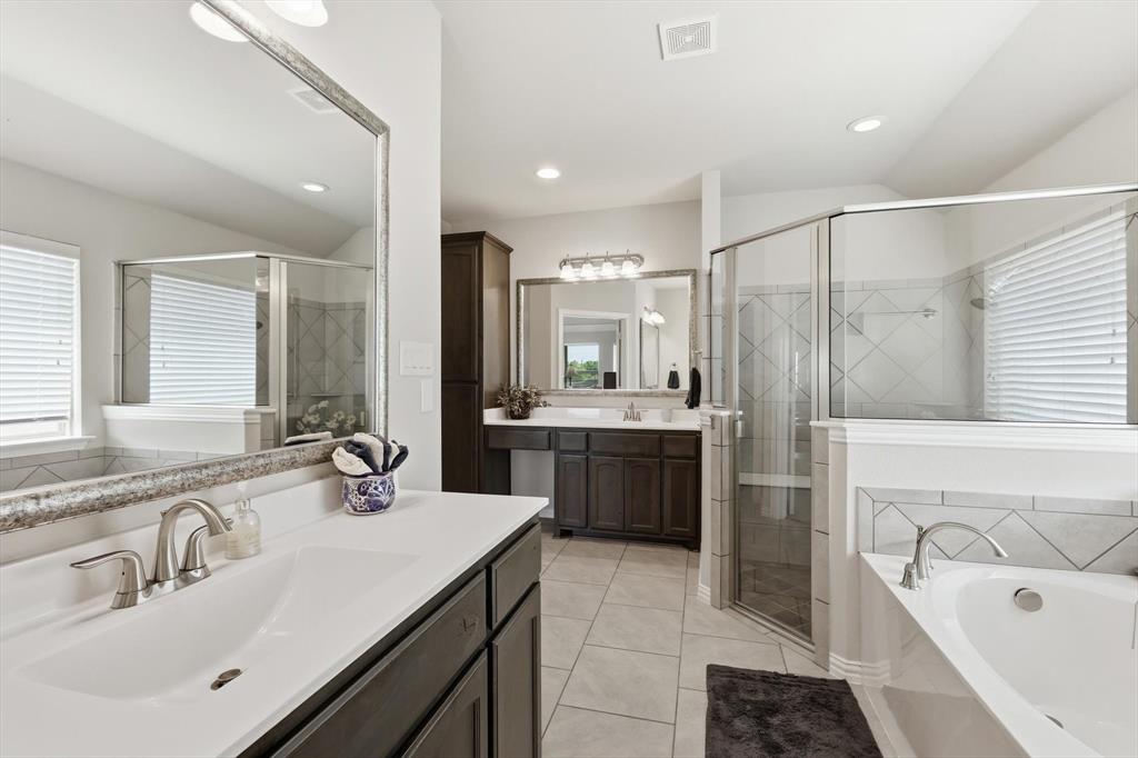 113 Heather Lane Decatur, TX 76234 - Photo 20 of 32 a bathroom with a tub sink double vanity and mirror
