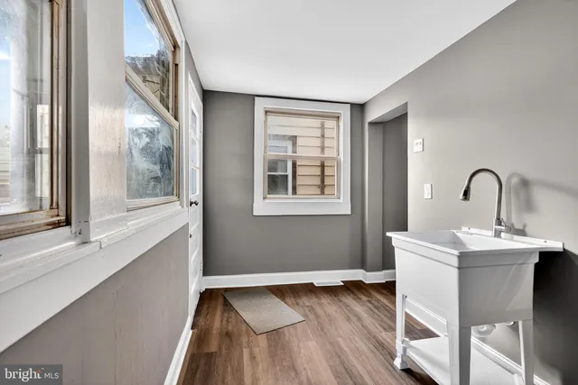 a view of a room with wooden floor and a window