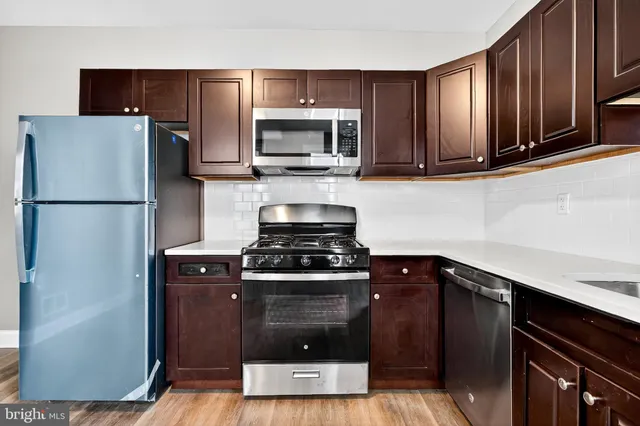 a kitchen with a refrigerator stove and microwave