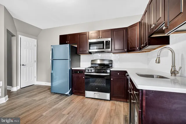a kitchen with stainless steel appliances granite countertop a refrigerator stove and microwave
