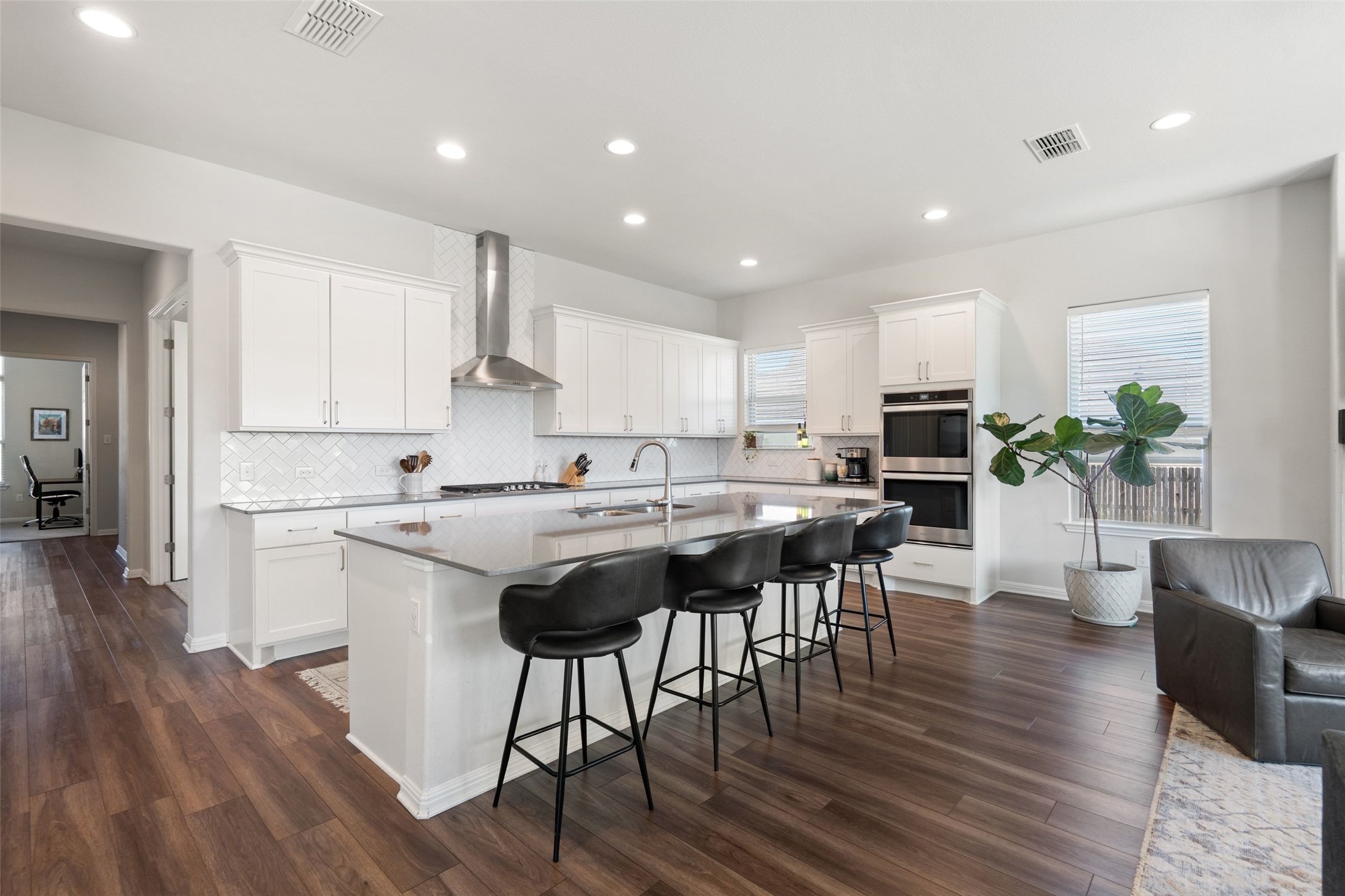 162 Lunar Loop Austin, TX 78737 - Photo 8 of 40 a kitchen with stainless steel appliances granite countertop a table chairs sink and cabinets