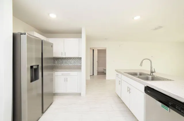a kitchen with a sink and refrigerator