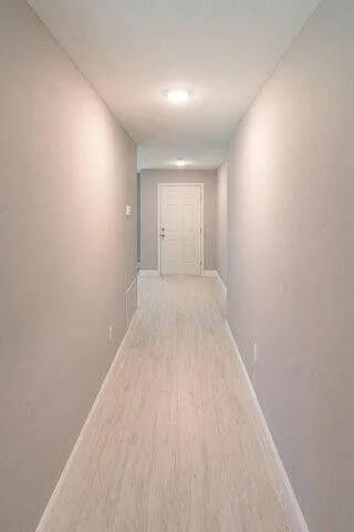 a view of a room with wooden floor and window