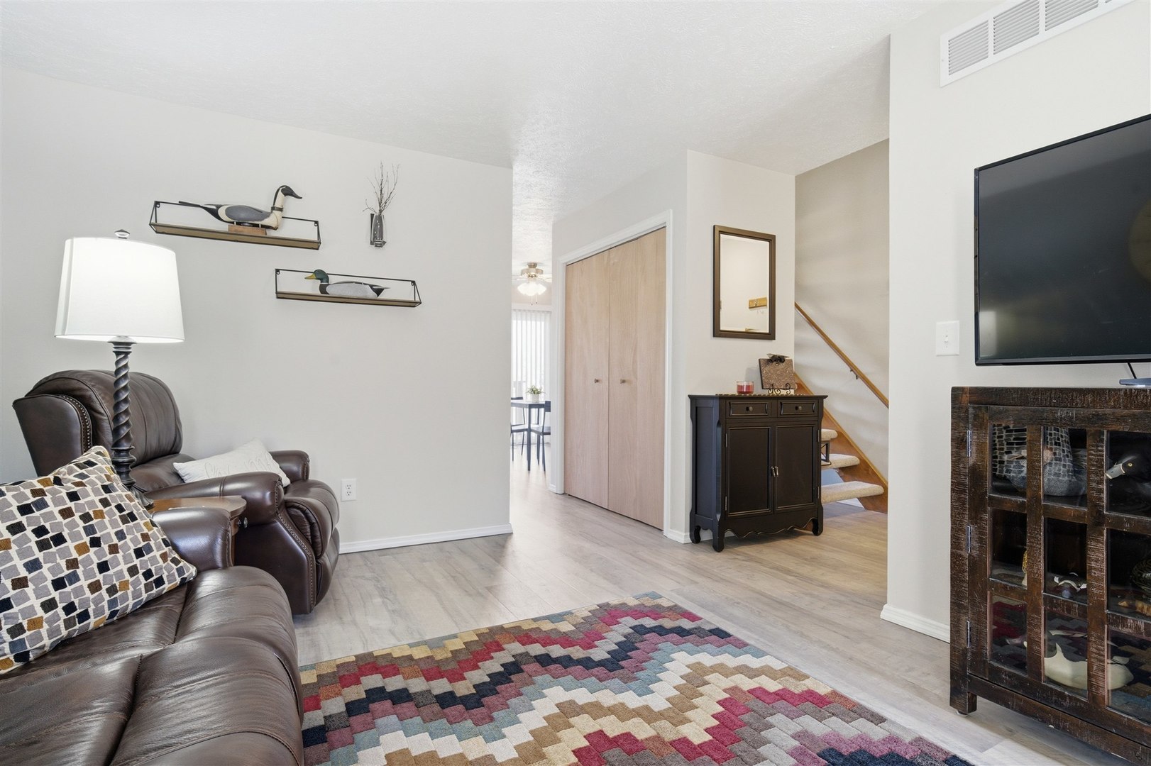 903 North Linden Street, Unit 108 Normal, IL 61761 - Photo 14 of 34 a living room with furniture and a flat screen tv