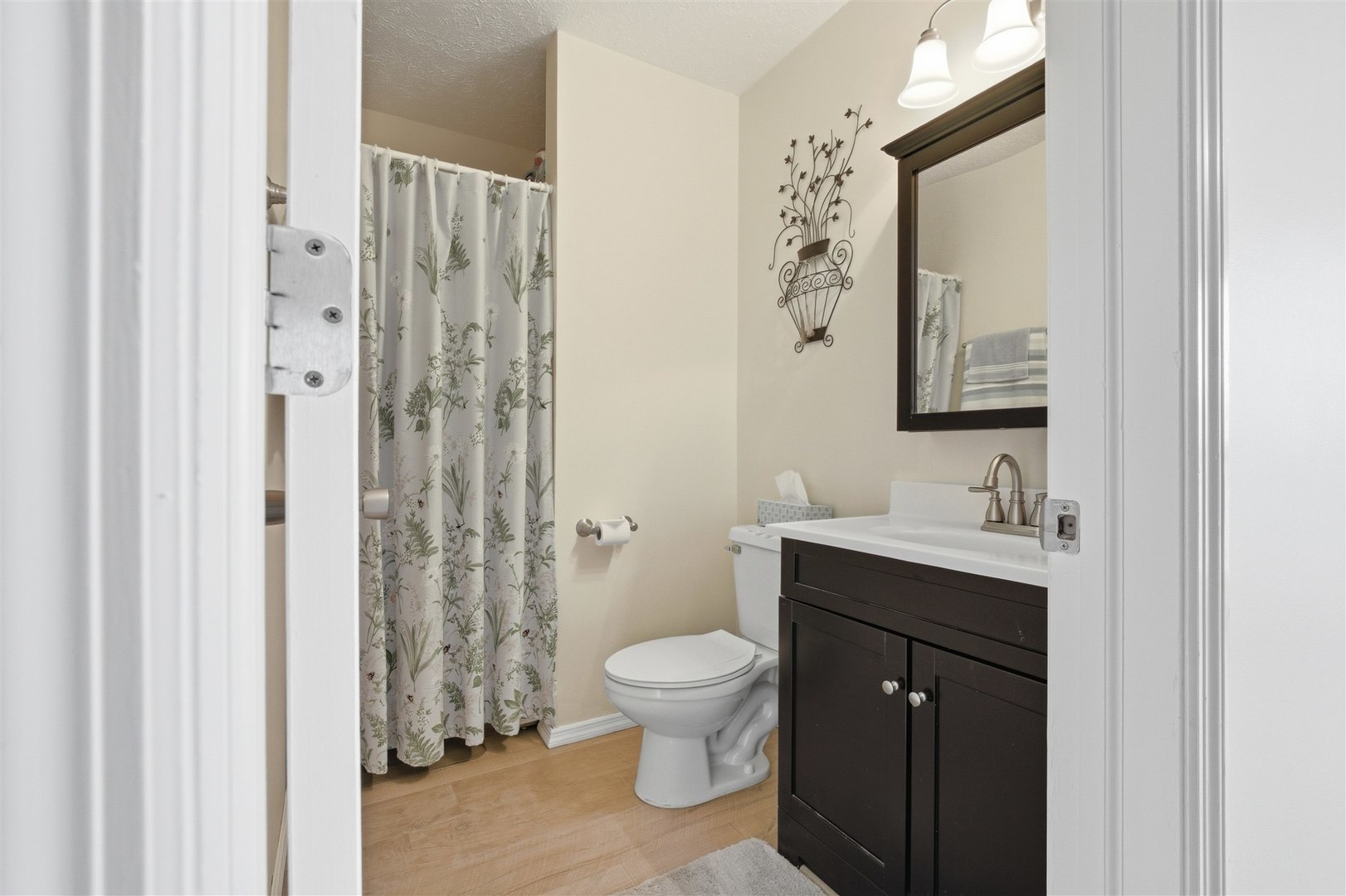 903 North Linden Street, Unit 108 Normal, IL 61761 - Photo 15 of 34 a bathroom with a granite countertop sink toilet a mirror a vanity and shower