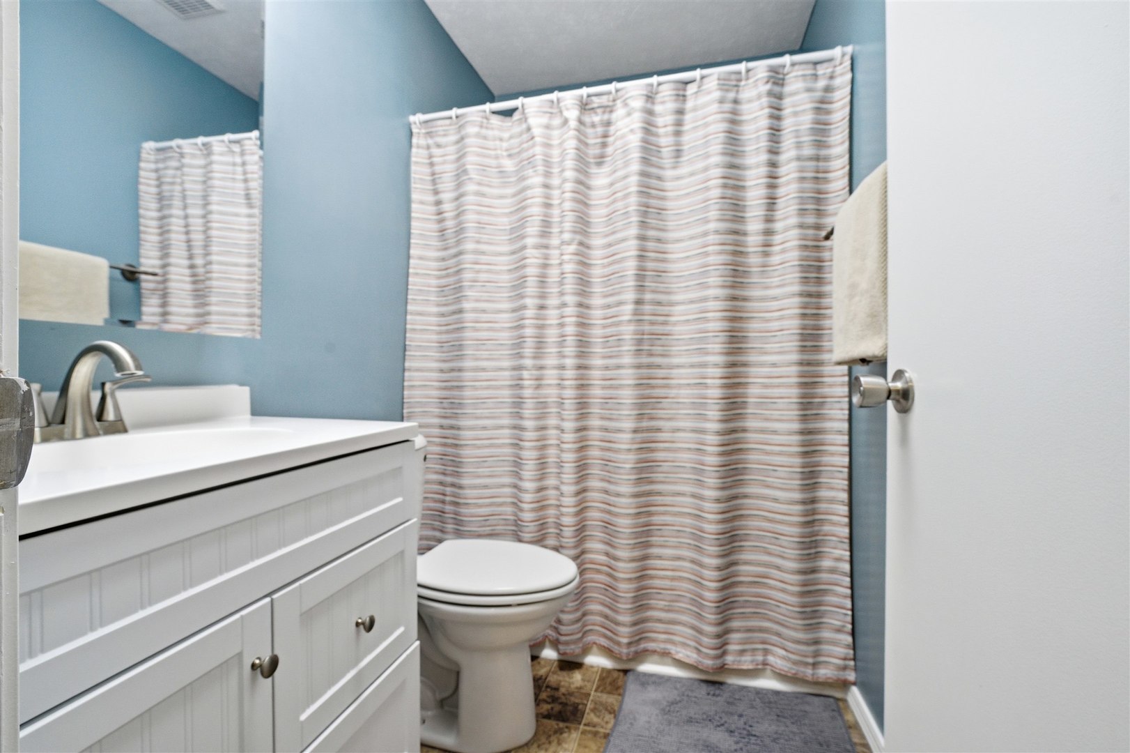 903 North Linden Street, Unit 108 Normal, IL 61761 - Photo 23 of 34 a bathroom with a sink a toilet and shower curtain