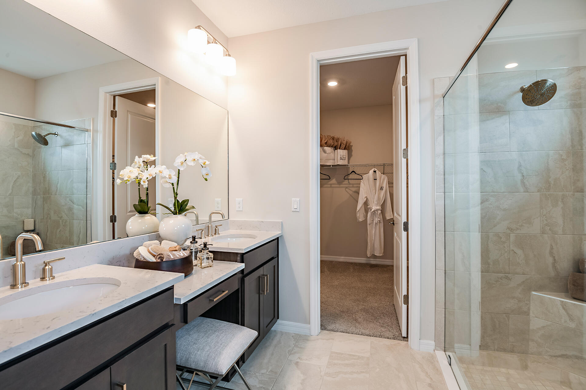 593 Southeast Ranch Oak Circle Port St. Lucie, FL 34984 - Photo 11 of 35 a bathroom with a granite countertop sink a mirror and a shower