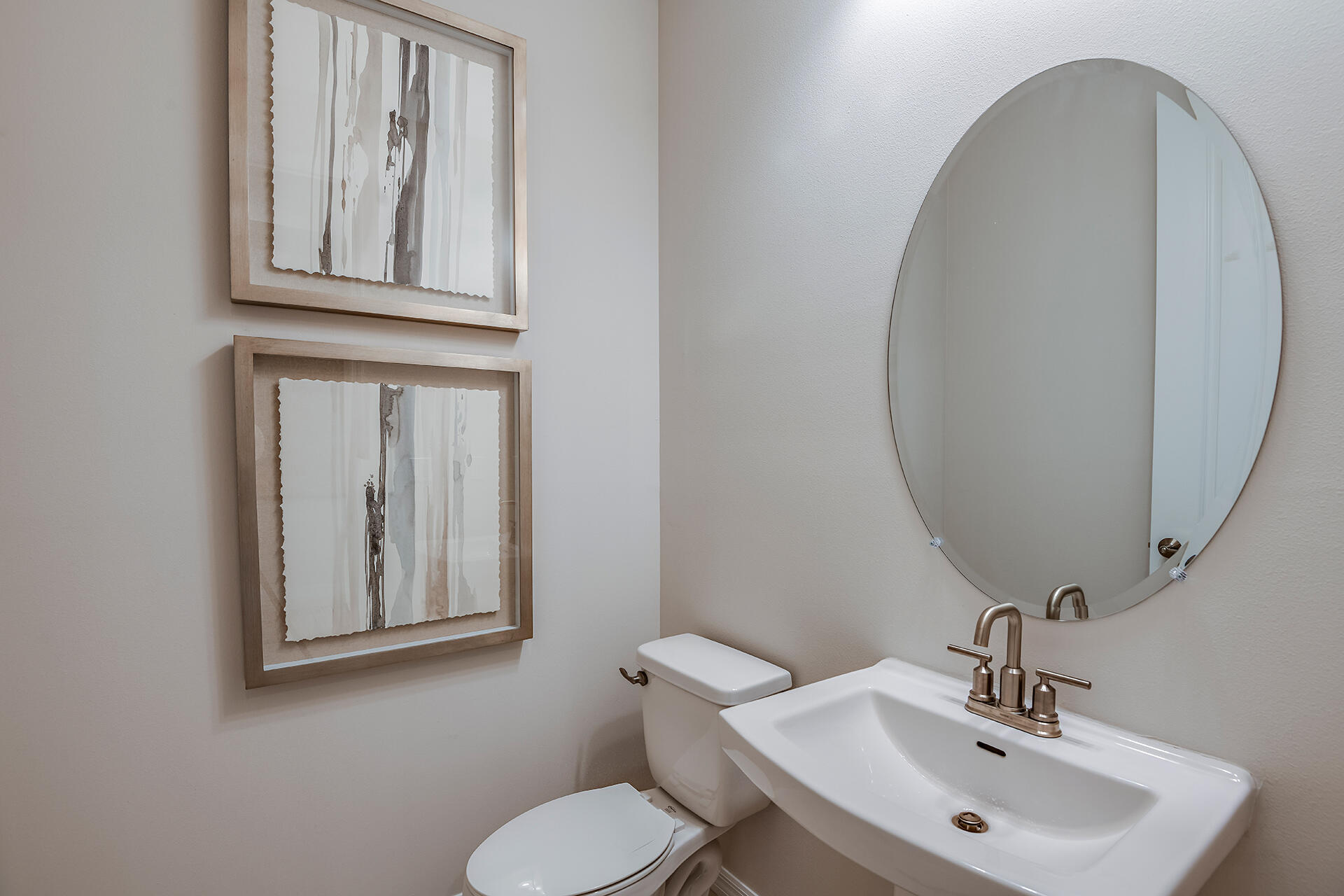 593 Southeast Ranch Oak Circle Port St. Lucie, FL 34984 - Photo 19 of 35 a bathroom with a toilet a sink and mirror