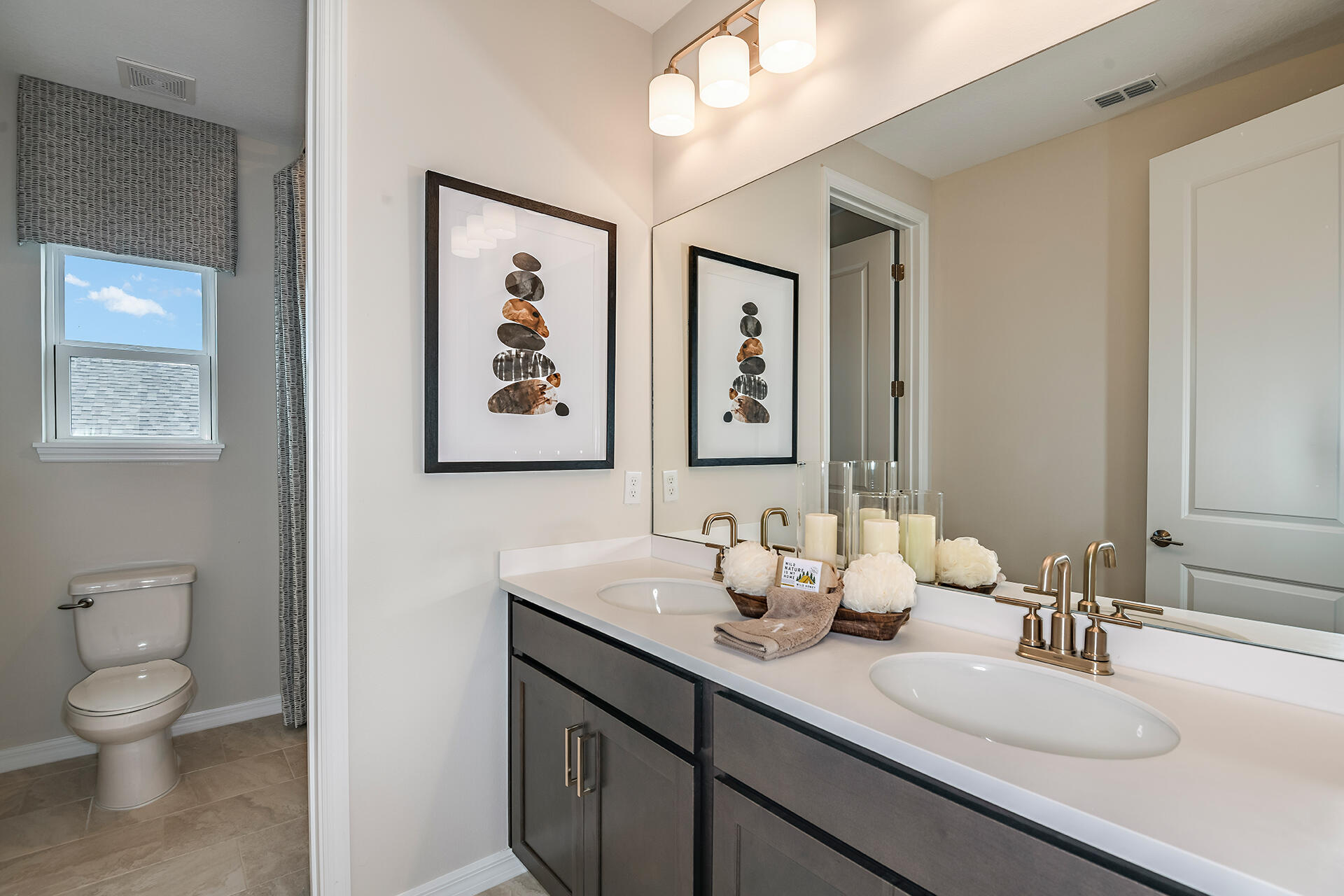 593 Southeast Ranch Oak Circle Port St. Lucie, FL 34984 - Photo 22 of 35 a bathroom with a toilet a sink and mirror
