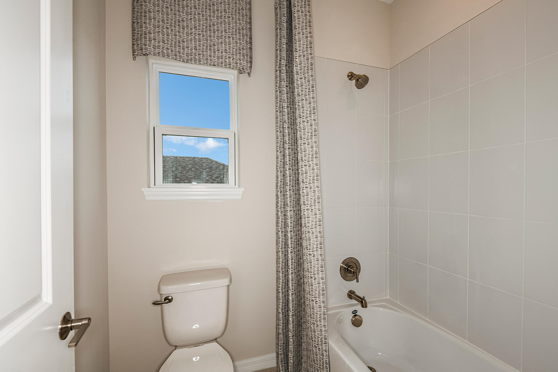593 Southeast Ranch Oak Circle Port St. Lucie, FL 34984 - Photo 23 of 35 a bathroom with a toilet and a shower