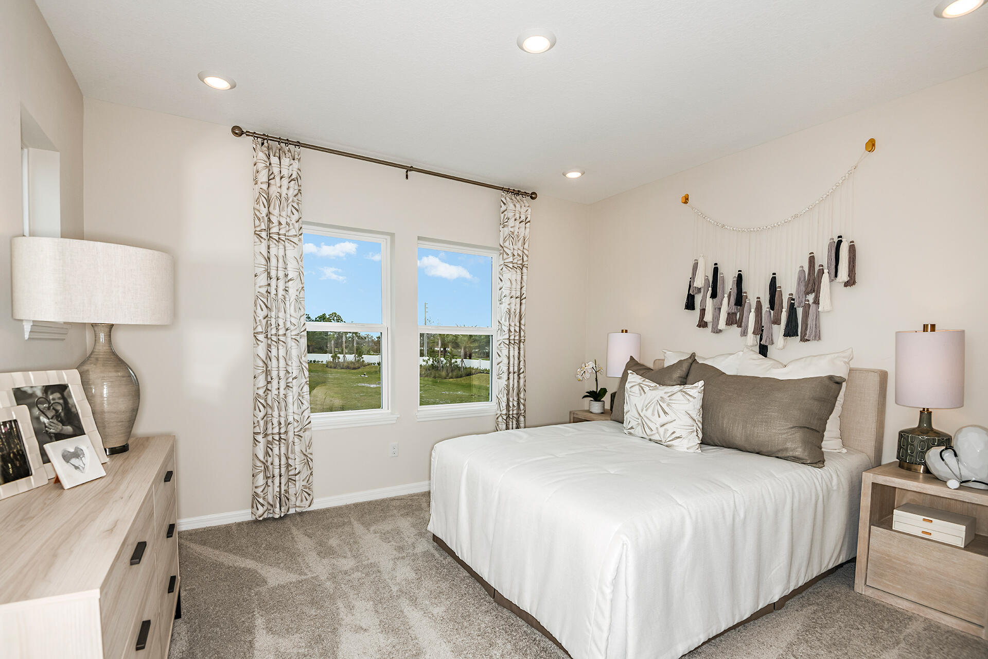 593 Southeast Ranch Oak Circle Port St. Lucie, FL 34984 - Photo 26 of 35 a bedroom with a large bed and a window