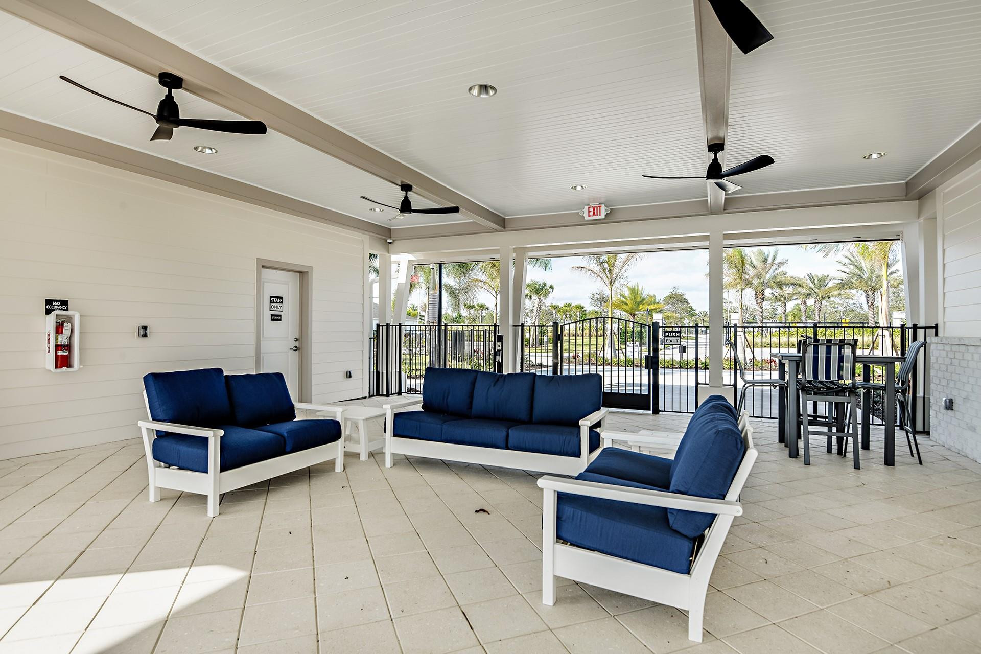 593 Southeast Ranch Oak Circle Port St. Lucie, FL 34984 - Photo 33 of 35 a living room with furniture and a large window
