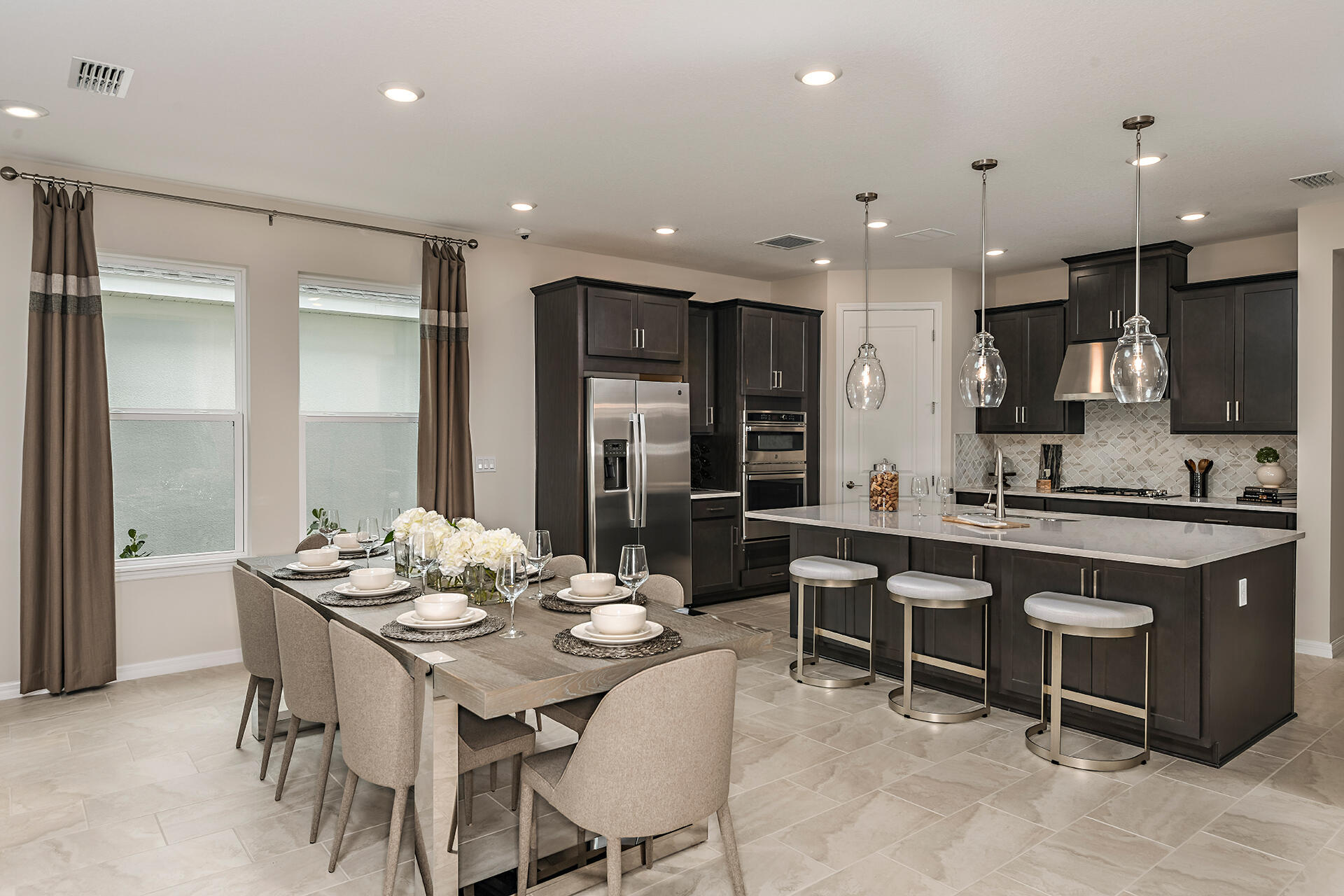 593 Southeast Ranch Oak Circle Port St. Lucie, FL 34984 - Photo 5 of 35 a kitchen with a dining table chairs and view kitchen