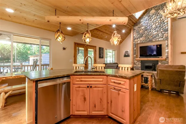 a kitchen with stainless steel appliances granite countertop a sink and cabinets