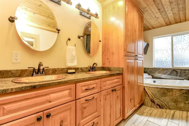 a bathroom with a double vanity sink and a mirror