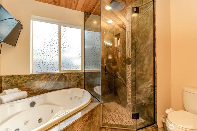 a bathroom with a bathtub and shower