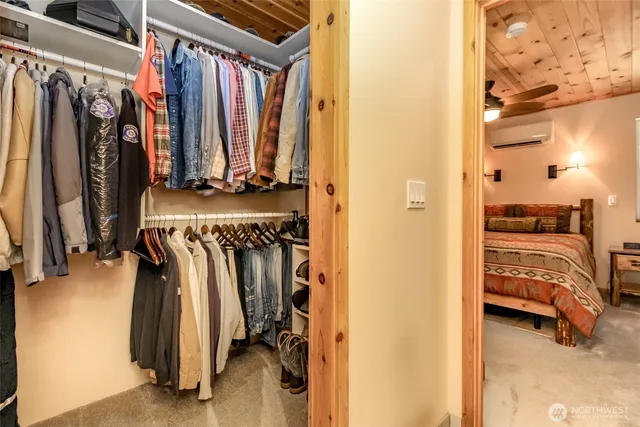 a view of walk in closet with clothes