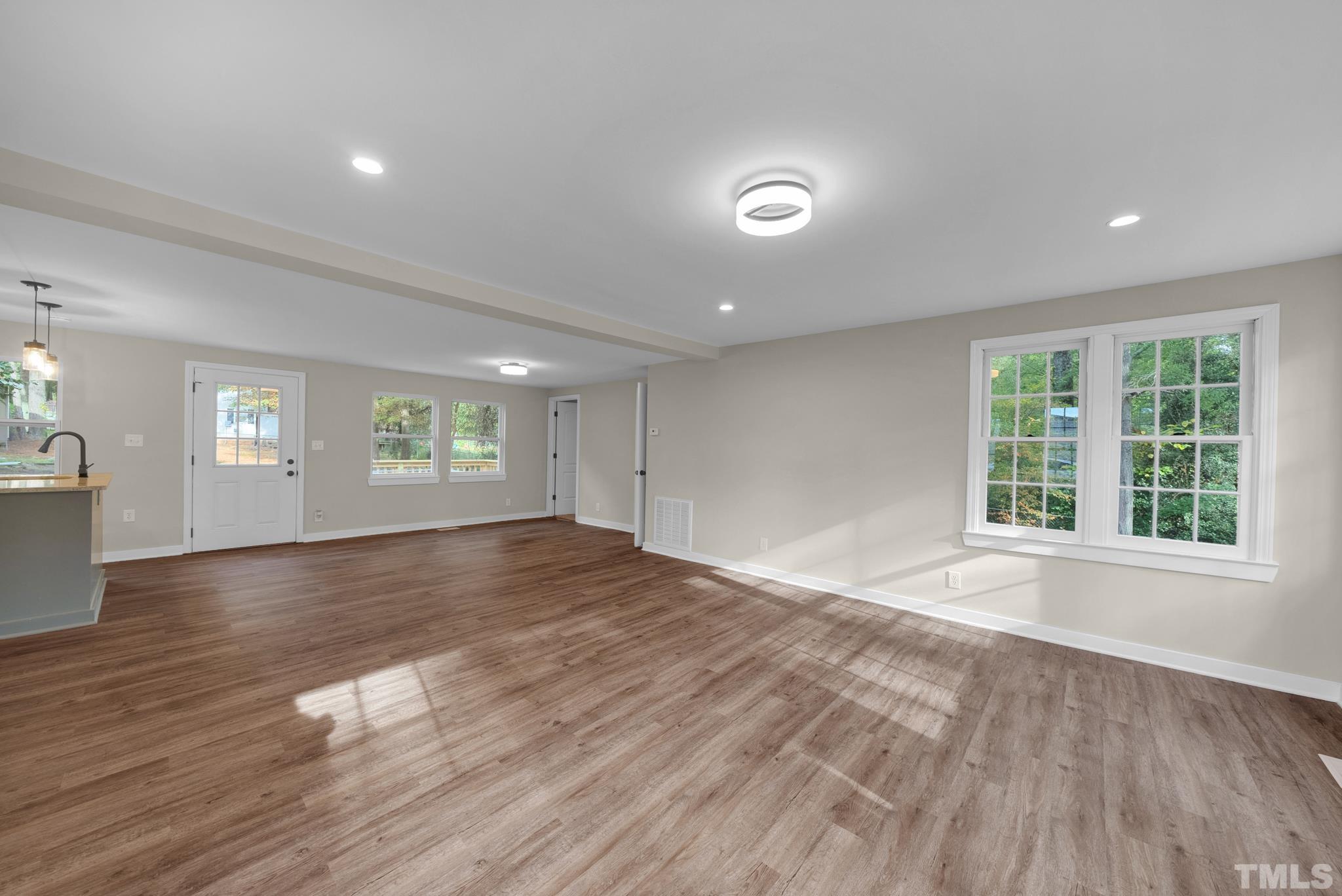 10844 Old Stage Road Raleigh, NC 27603 - Photo 2 of 17 an empty room with wooden floor and windows