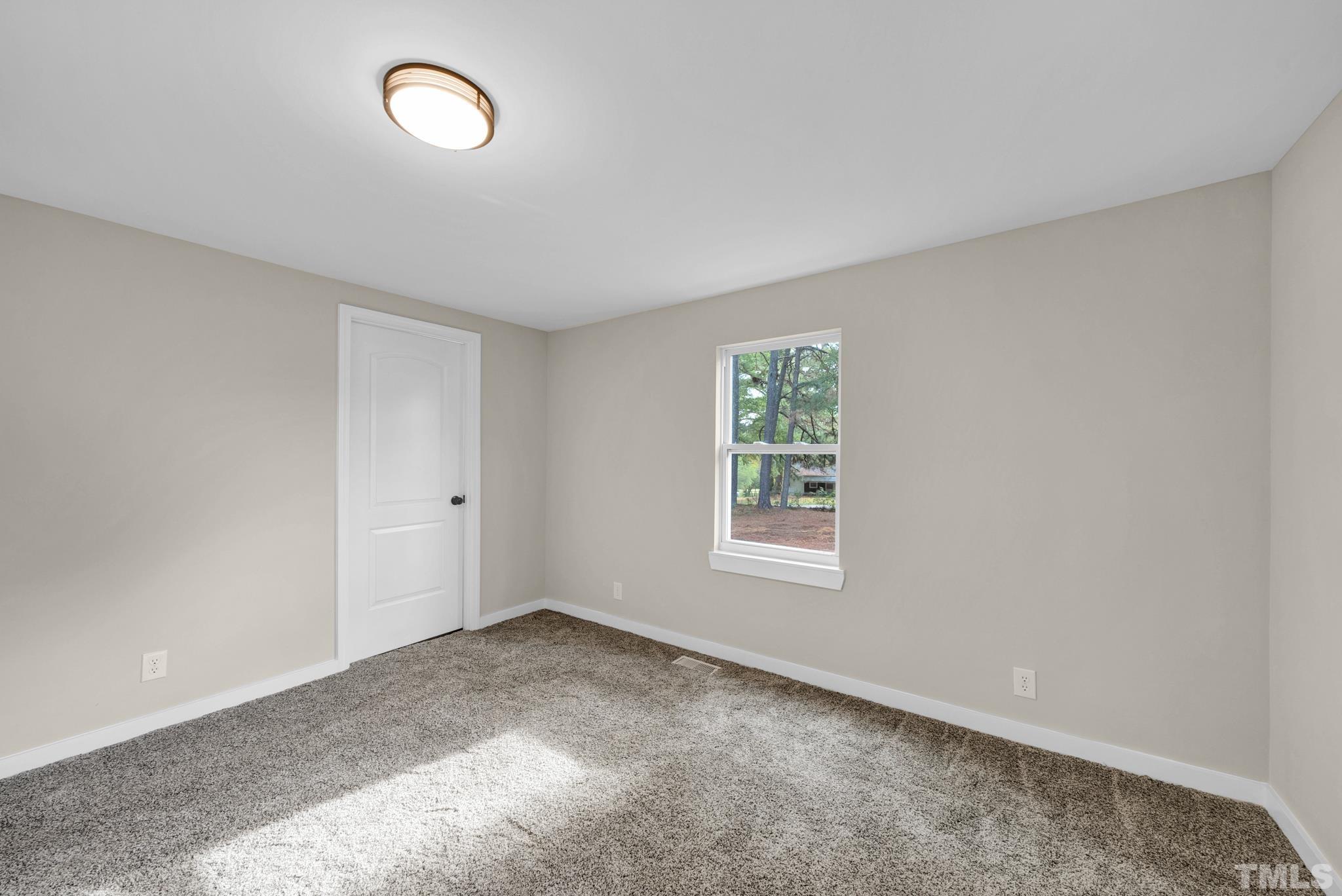 10844 Old Stage Road Raleigh, NC 27603 - Photo 12 of 17 an empty room with a window