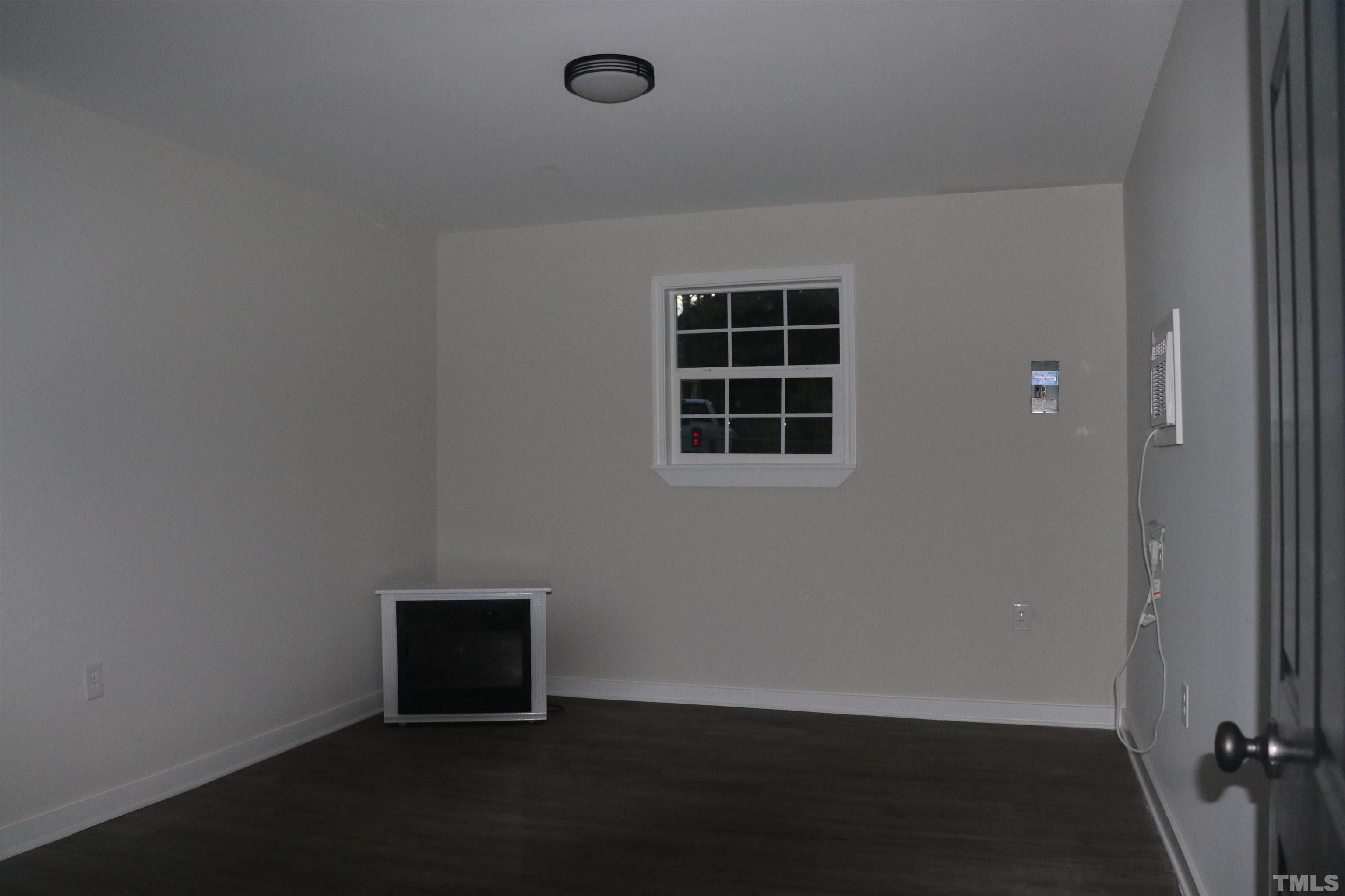 10844 Old Stage Road Raleigh, NC 27603 - Photo 17 of 17 an empty room with wooden floor and windows
