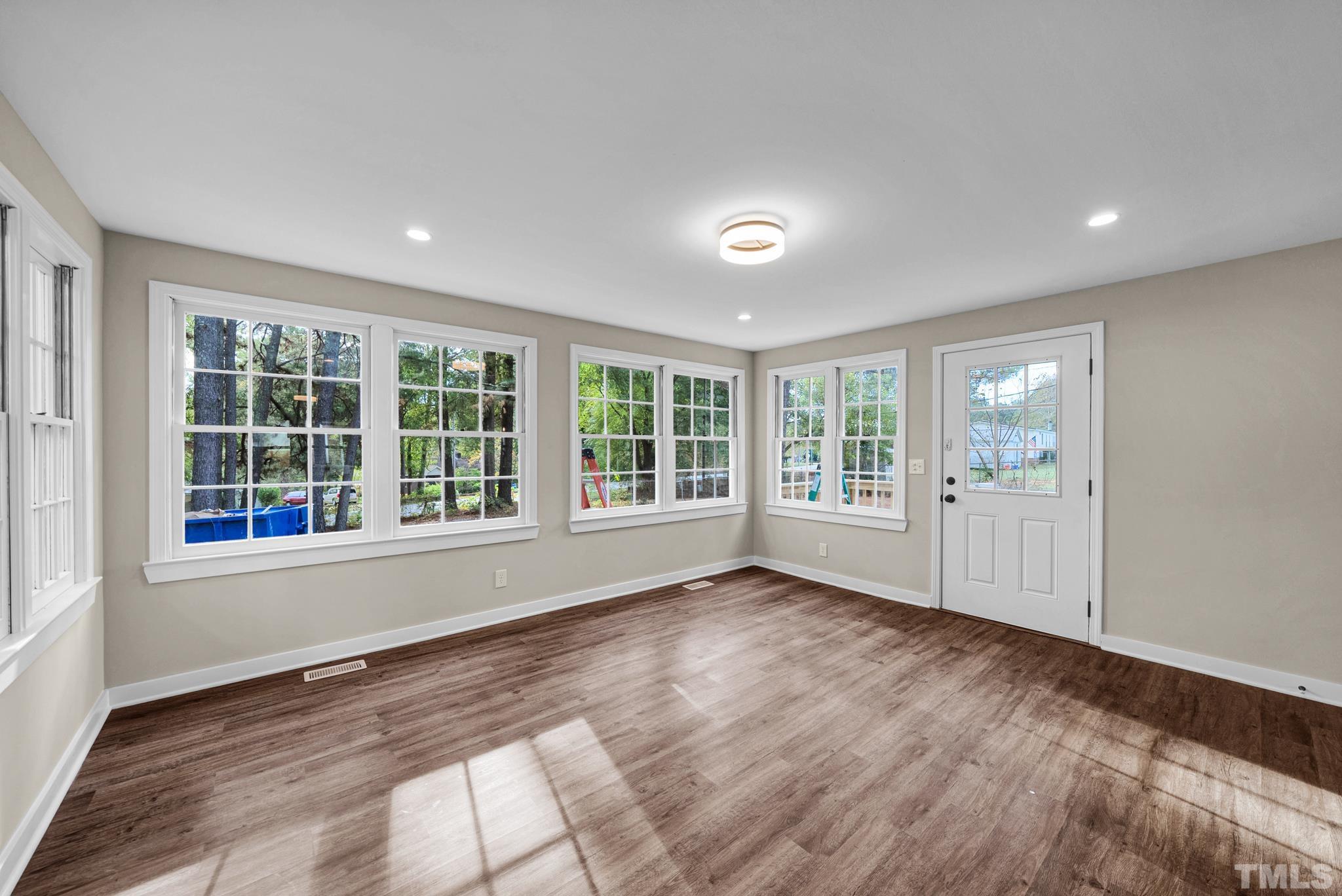10844 Old Stage Road Raleigh, NC 27603 - Photo 5 of 17 a view of an empty room with wooden floor and a window