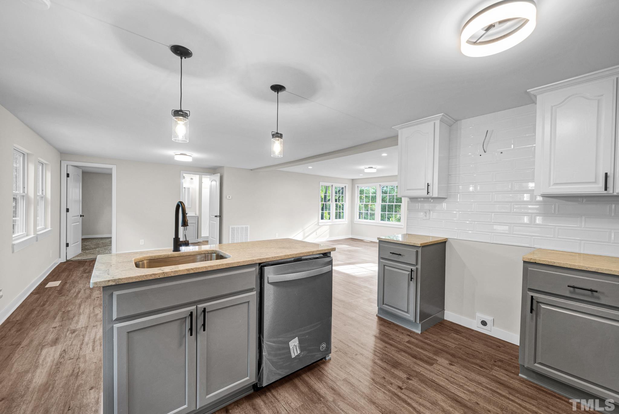 10844 Old Stage Road Raleigh, NC 27603 - Photo 6 of 17 a kitchen with a sink stove and cabinets