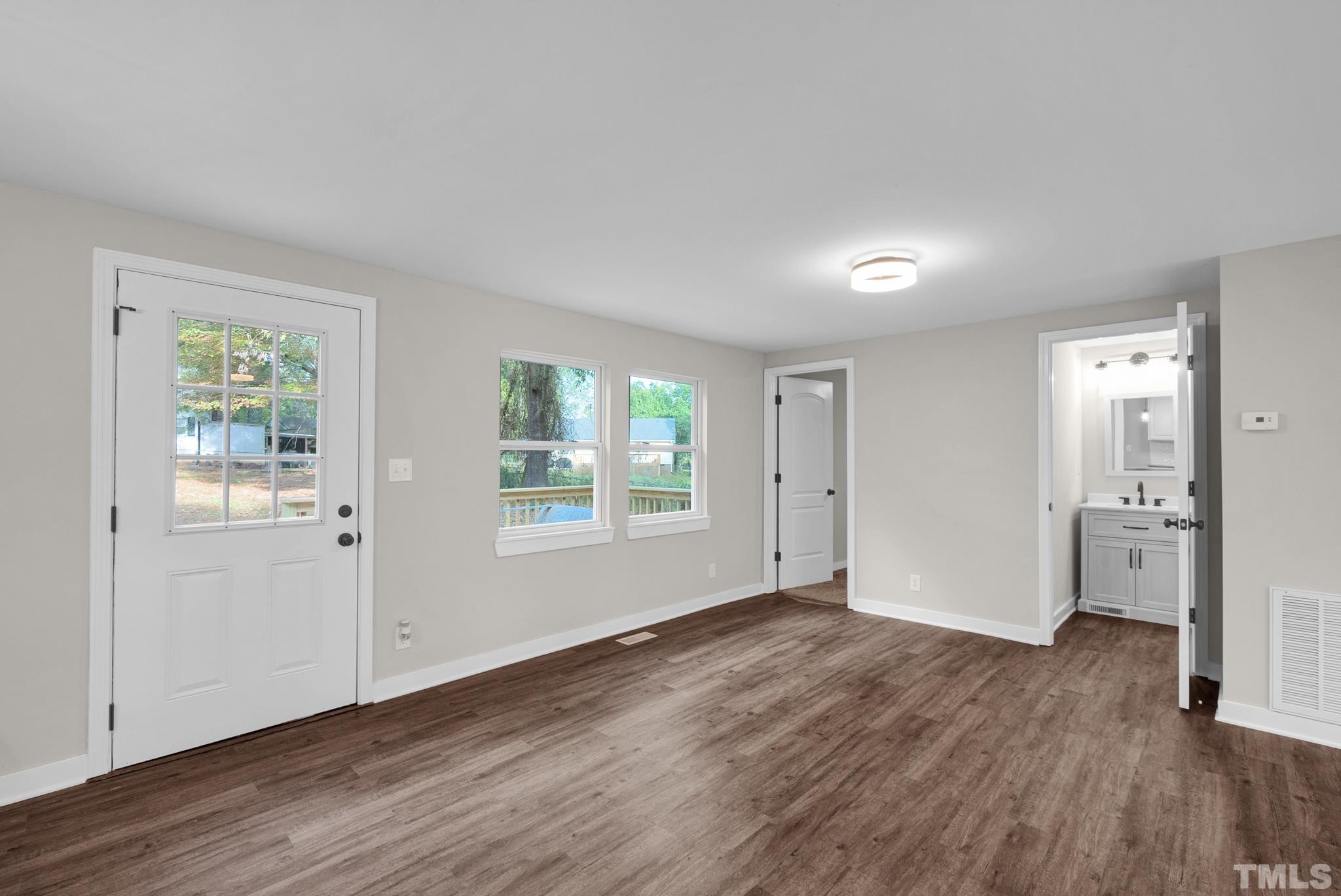 10844 Old Stage Road Raleigh, NC 27603 - Photo 9 of 17 an empty room with wooden floor and windows