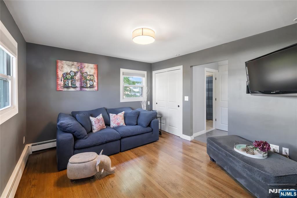 34 William Street Wallington, NJ 07057 - Photo 11 of 26 a living room with furniture and a flat screen tv