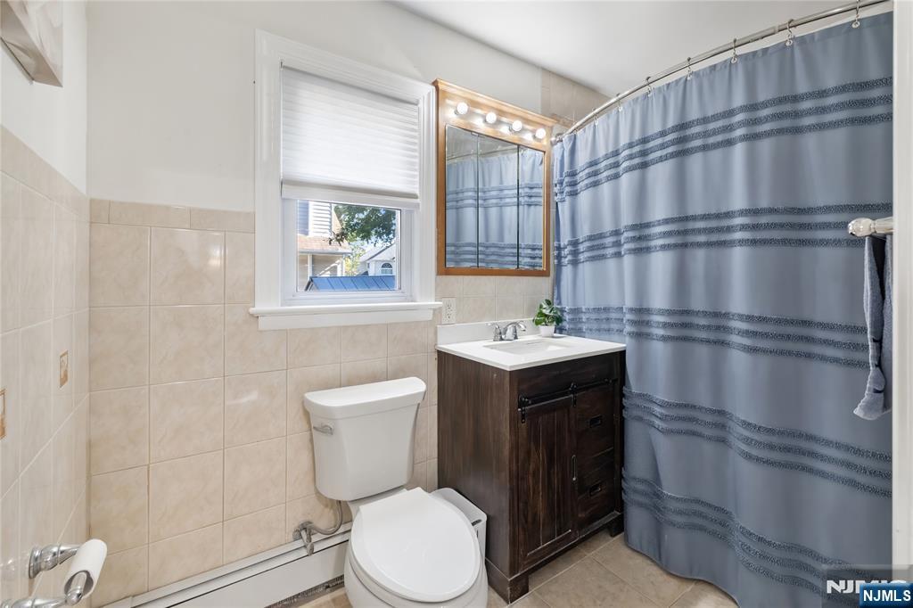 34 William Street Wallington, NJ 07057 - Photo 13 of 26 a bathroom with a toilet sink and shower