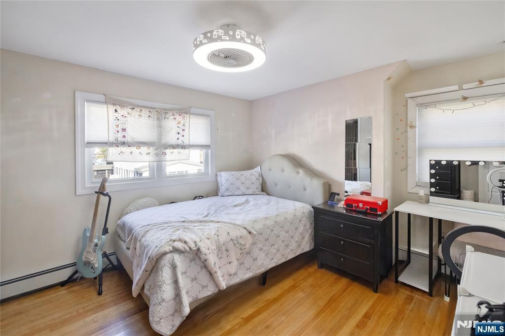 34 William Street Wallington, NJ 07057 - Photo 20 of 26 a bedroom with a bed closet and a window