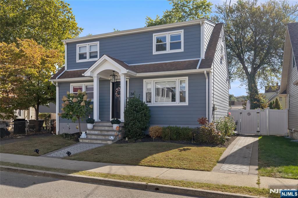 34 William Street Wallington, NJ 07057 - Photo 2 of 26 a front view of a house with garage and plants