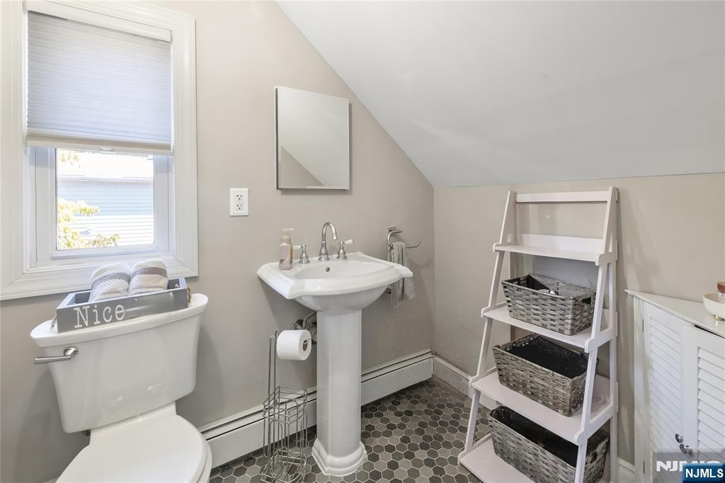 34 William Street Wallington, NJ 07057 - Photo 22 of 26 a bathroom with a sink toilet and shower