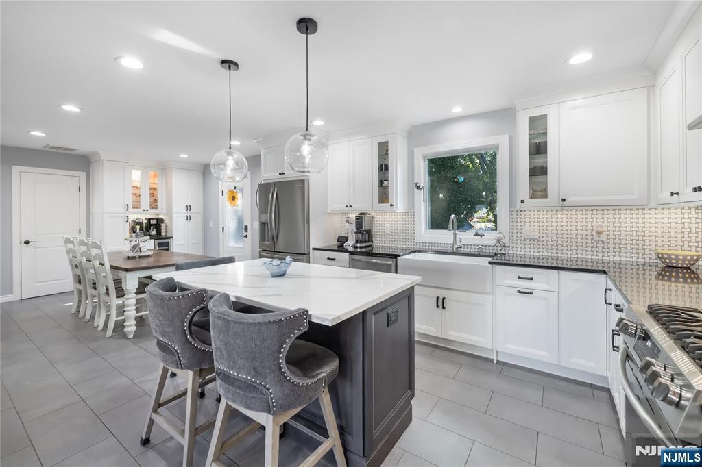 34 William Street Wallington, NJ 07057 - Photo 4 of 26 a kitchen with center island table and chairs