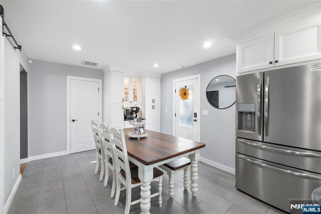 34 William Street Wallington, NJ 07057 - Photo 8 of 26 a kitchen with stainless steel appliances a dining table chairs refrigerator and sink