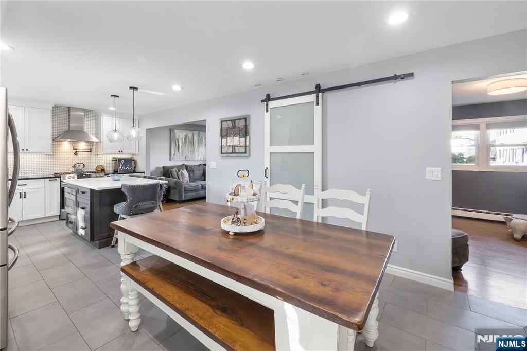 34 William Street Wallington, NJ 07057 - Photo 9 of 26 a open dining room with stainless steel appliances kitchen island granite countertop a table chairs and a refrigerator